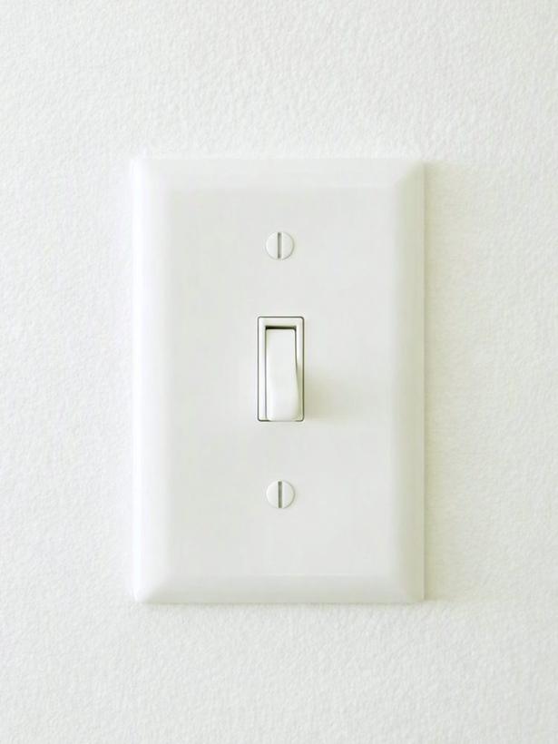 White light switch on a textured wall